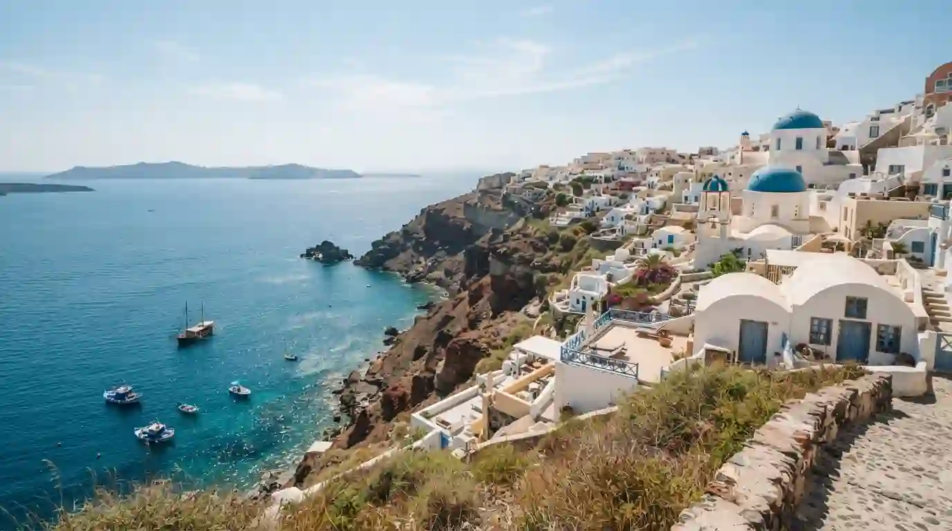 Greek island coastline with whitewashed buildings and blue sea during summer